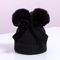 Knitted pompom hat with velvet bow